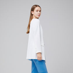 Image of Female doctor in a white lab coat and blue scrubs, standing in a side profile, showing the back details of the coat,White