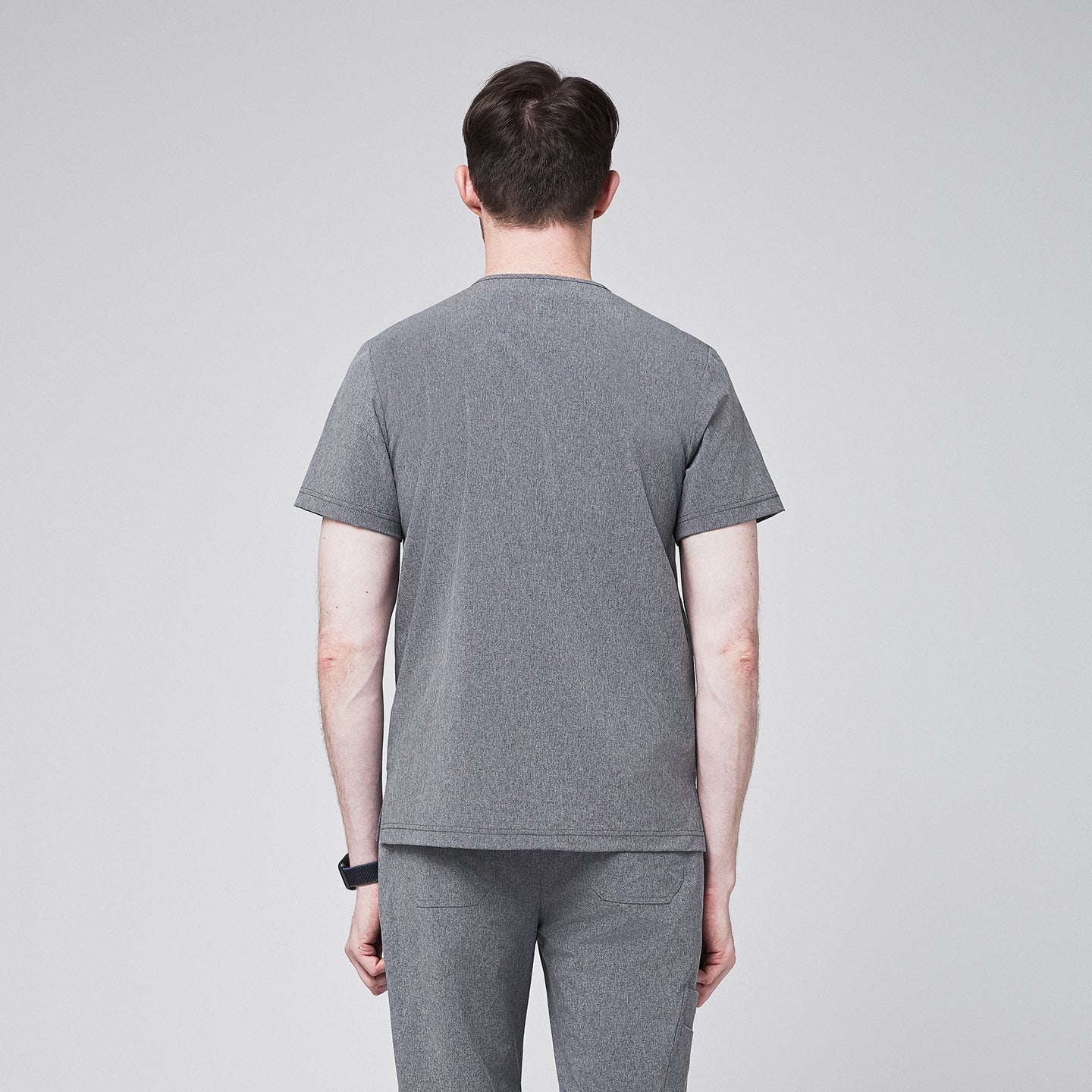 Man in ash gray scrubs with short sleeves and matching pants, viewed from behind,Ash Gray