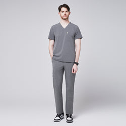 Image of Man wearing ash gray scrubs with a V-neck and a single chest pocket, paired with matching pants and black sneakers,Ash Gray