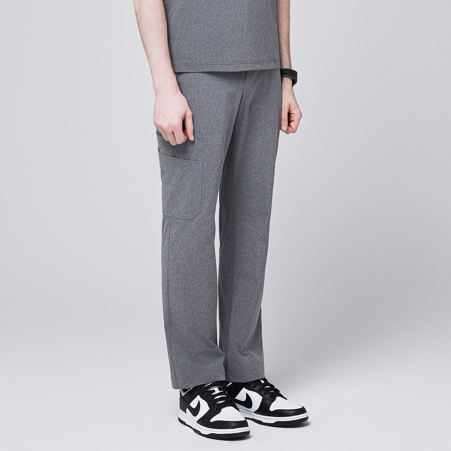 Ash gray scrub pants with a straight-leg fit and side pocket, styled with black-and-white sneakers,Ash Gray