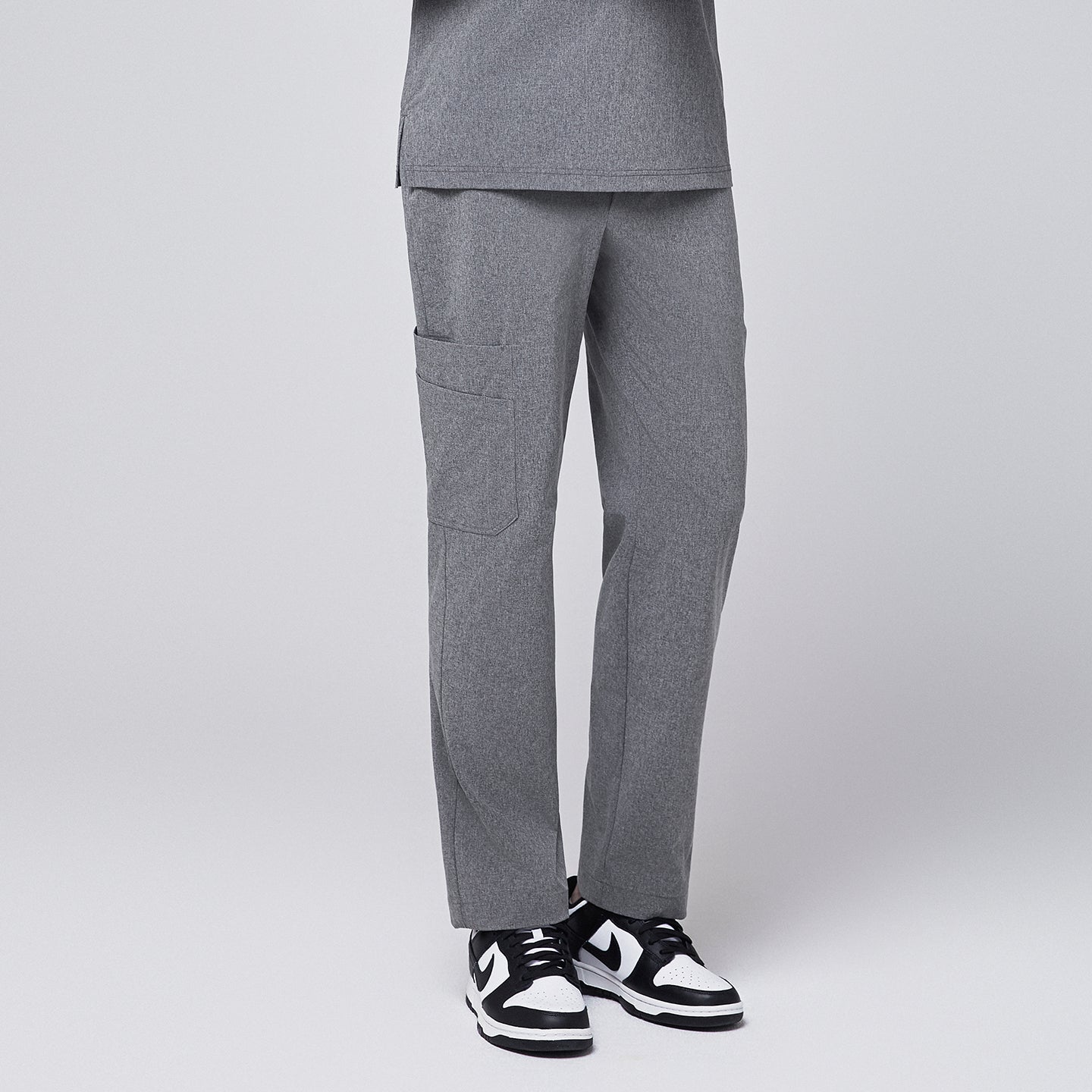 Ash gray scrub pants featuring a straight-leg fit and a functional side pocket, paired with black-and-white sneakers,Ash Gray