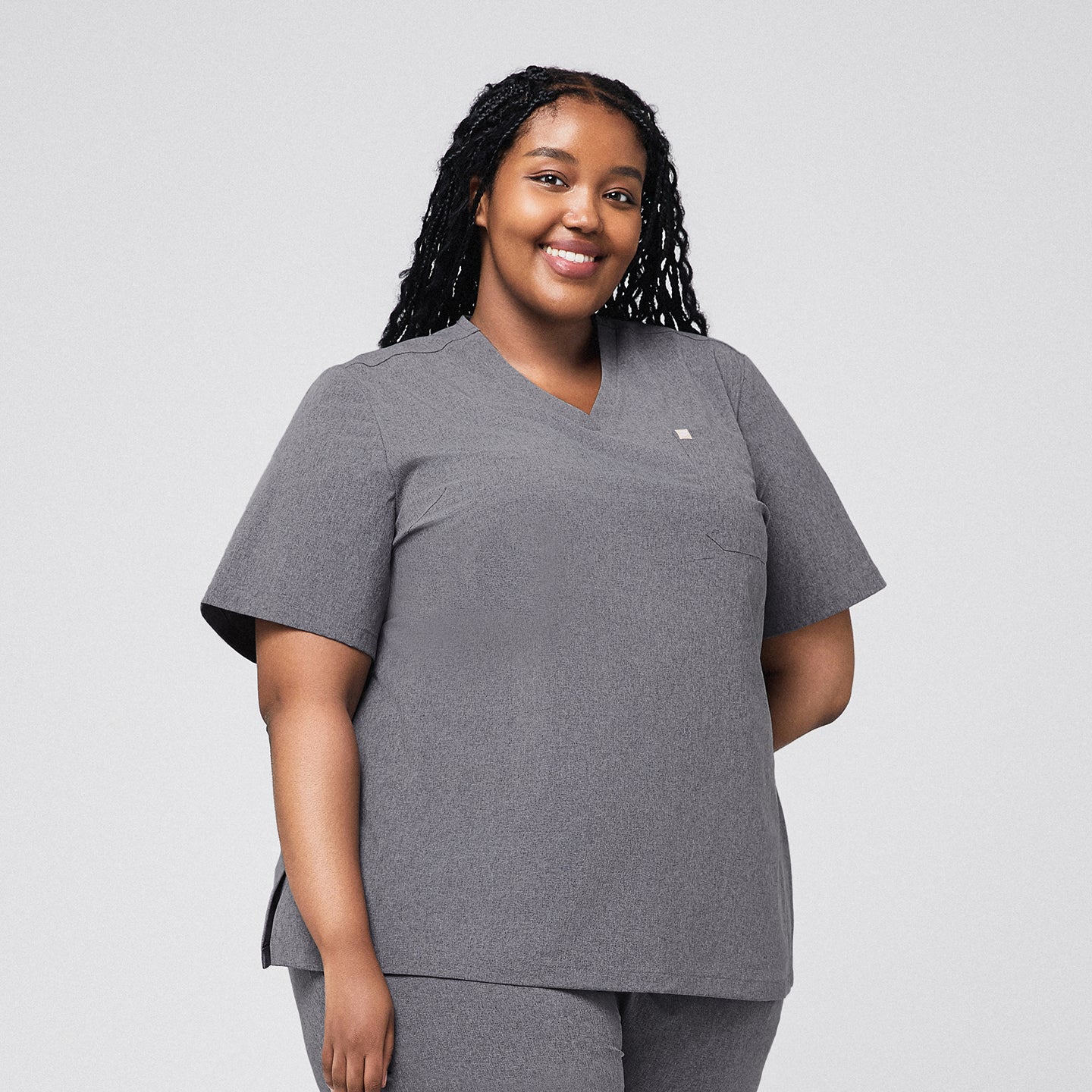 Healthcare worker wearing ash gray scrub top with a single pocket, front view,Ash Gray