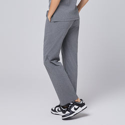 Image of Back view of ash gray straight-leg scrub pants with a split hem, paired with black-and-white sneakers on a neutral background,Ash Gray