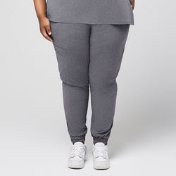 Image of Plus-size ash gray jogger scrub pants with elastic cuffs, cargo pocket, and stretch fit, paired with white sneakers on neutral background,Ash Gray