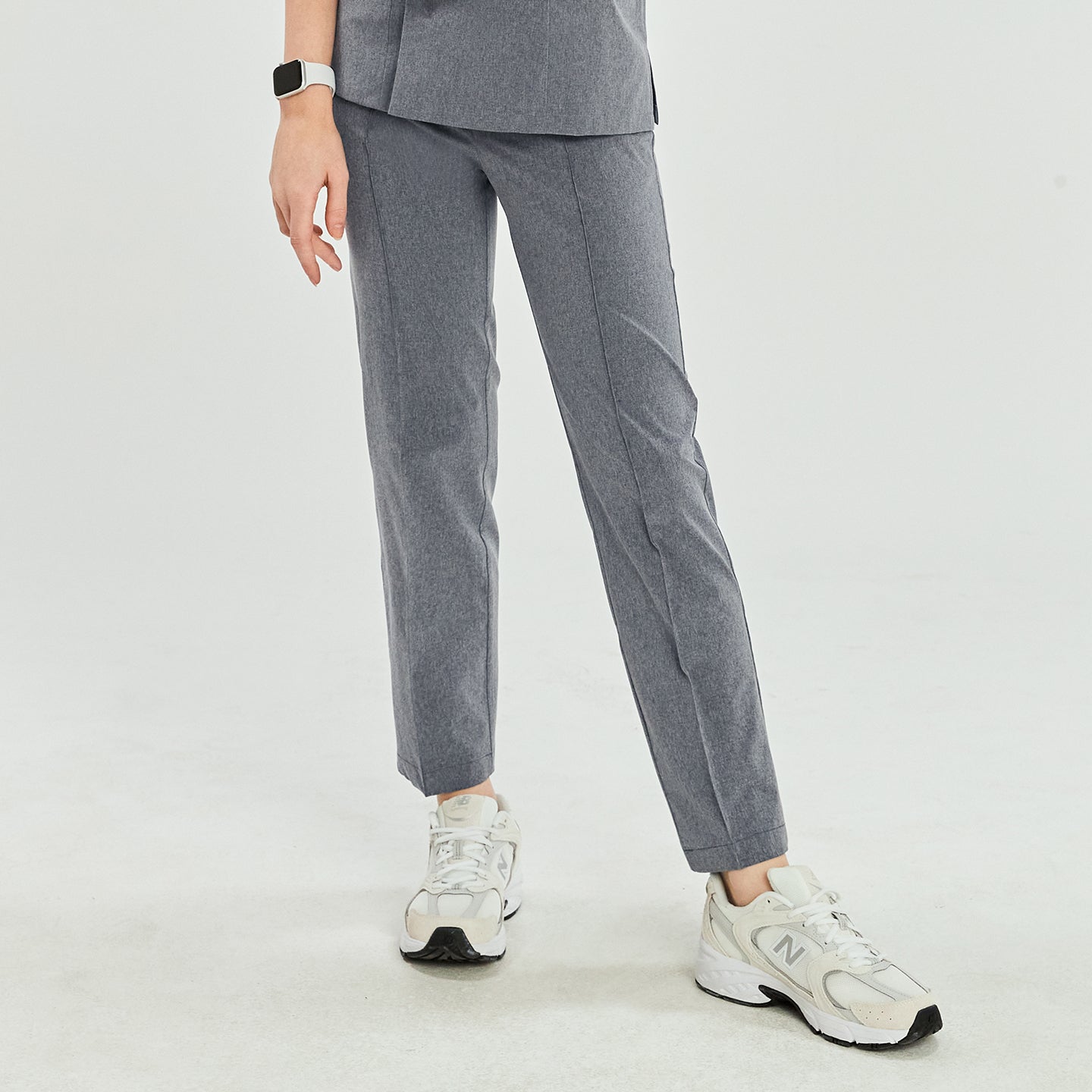 Ash gray scrub pants with straight legs, paired with white sneakers, shown in a casual walking stance,Ash Gray