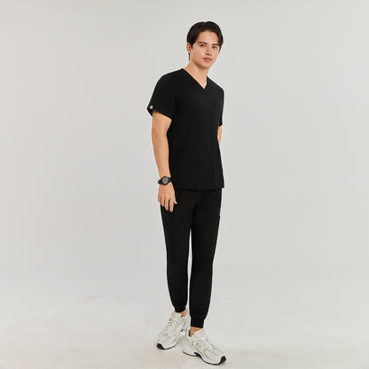 Man in black Zenir scrub top with chest pocket, standing and looking at the camera, full-body view,Black