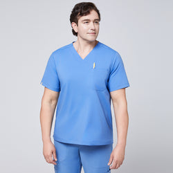 Image of Male model wearing a ceil blue V-neck scrub set with a chest pocket holding a yellow pen, designed for a professional and clean medical uniform appearance,Ceil Blue