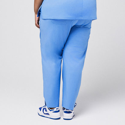 Back view of blue scrub pants with split hem, paired with blue sneakers,Ceil Blue