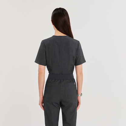 Female model wearing a charcoal gray 3-pocket scrub top and matching pants, showcasing a streamlined and professional look for healthcare settings,Charcoal Gray