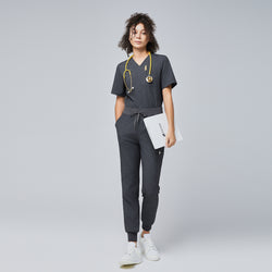 Image of Woman wearing a charcoal gray scrub set with a drawstring waist, holding a folder, and a yellow stethoscope around her neck, paired with white sneakers,Charcoal Gray