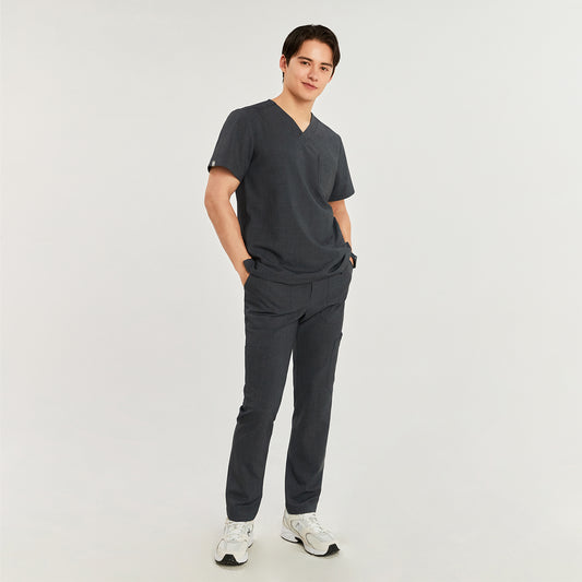 Model wearing straight scrub pants with zipper details and side pockets, paired with a V-neck scrub top and white athletic shoes,Charcoal Gray