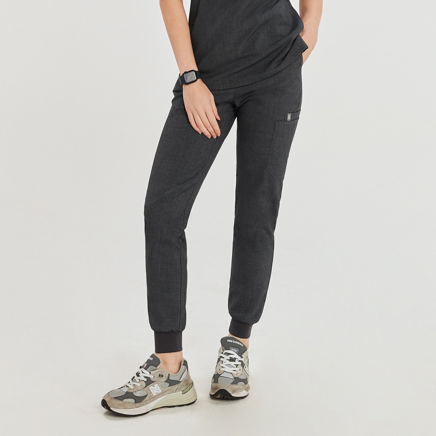 Charcoal gray jogger scrub pants with a drawstring waist, side pockets, and a close-up front view showcasing the detailed fit and practical design,Charcoal Gray