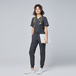 Image of Full-body view of a woman wearing charcoal gray jogger scrub pants and matching top, accessorized with a yellow stethoscope and holding a clipboard,Charcoal Gray