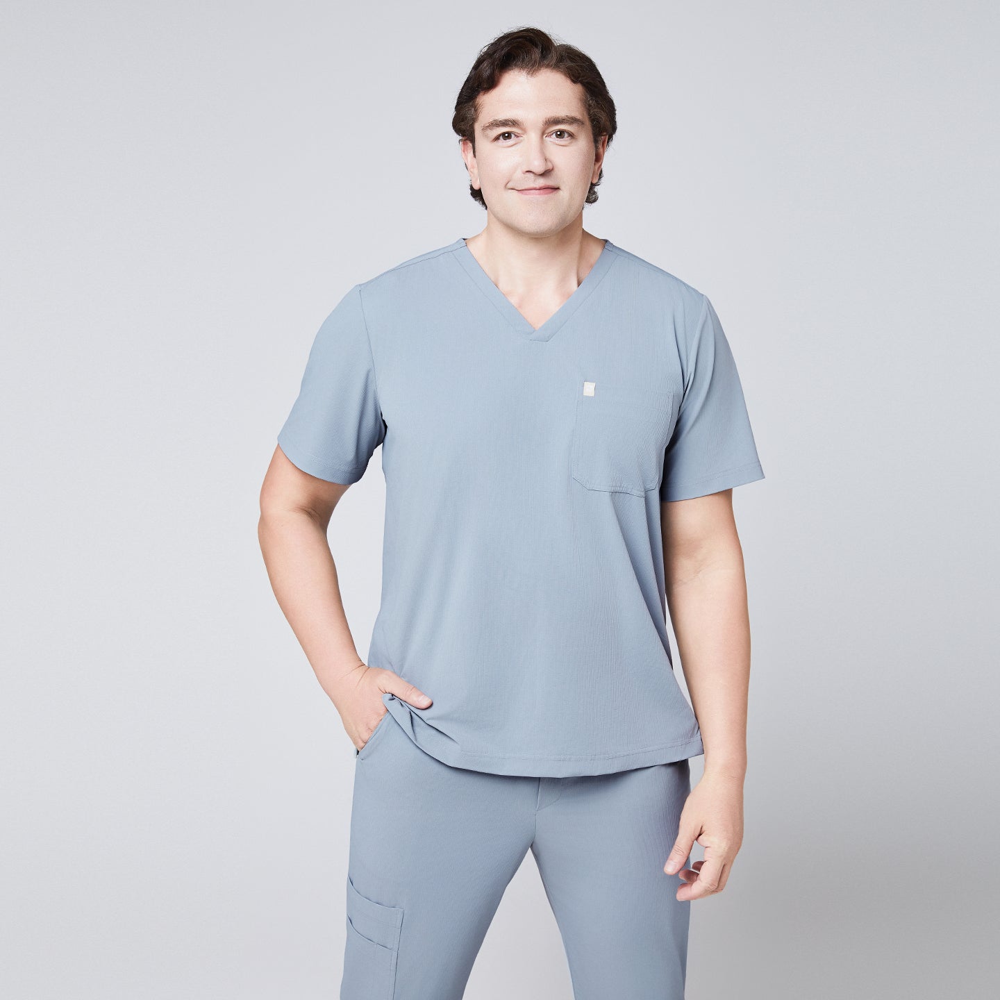 Man wearing a cool gray scrub set with a single-pocket V-neck top, designed for medical professionals,Cool Gray