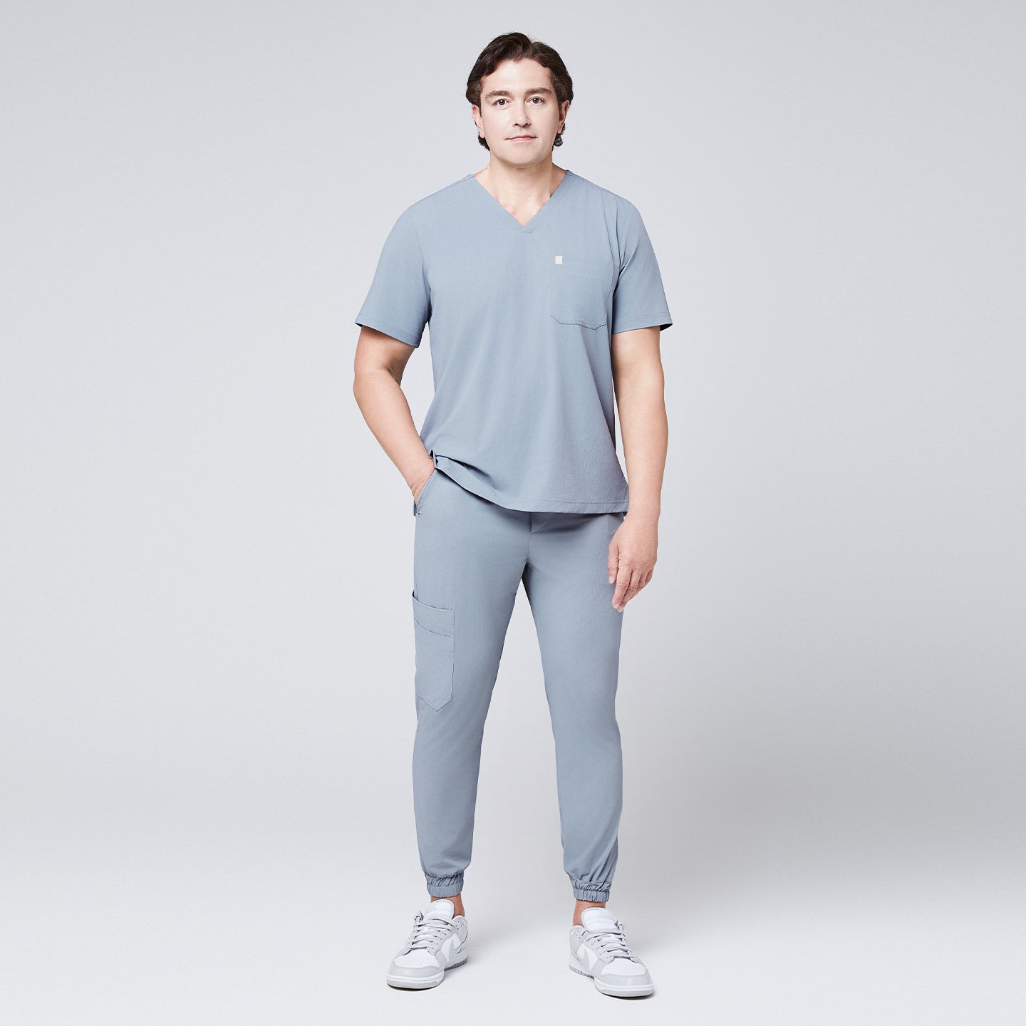 Man wearing a cool gray scrub set with a single-pocket V-neck top, designed for medical professionals,Cool Gray