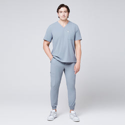 Image of Man wearing a cool gray scrub set with a single-pocket V-neck top, designed for medical professionals,Cool Gray