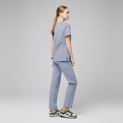 Image of Model in cool gray scrubs, standing with back turned, wearing green and white sneakers,Cool Gray