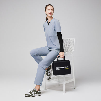 Woman in cool gray scrubs with split hem pants, sitting on a chair holding an emergency kit, wearing green and white sneakers,Cool Gray