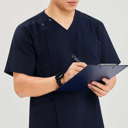 Close-up of man in a front zipper scrub top with chest and side pockets, holding a blue clipboard and pen,Navy