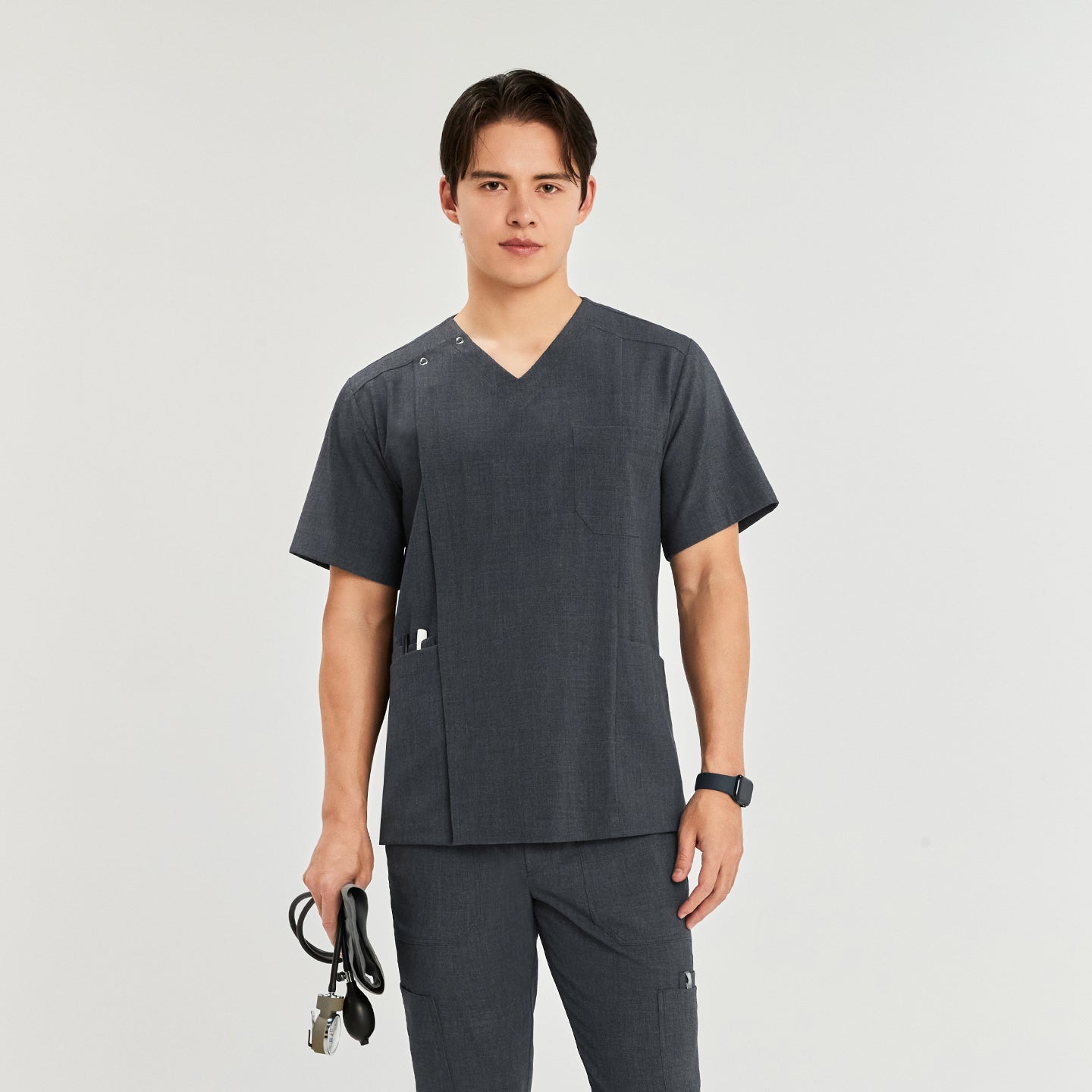 Man in a front zipper scrub top with matching cargo pants, holding a blood pressure monitor,Charcoal Gray