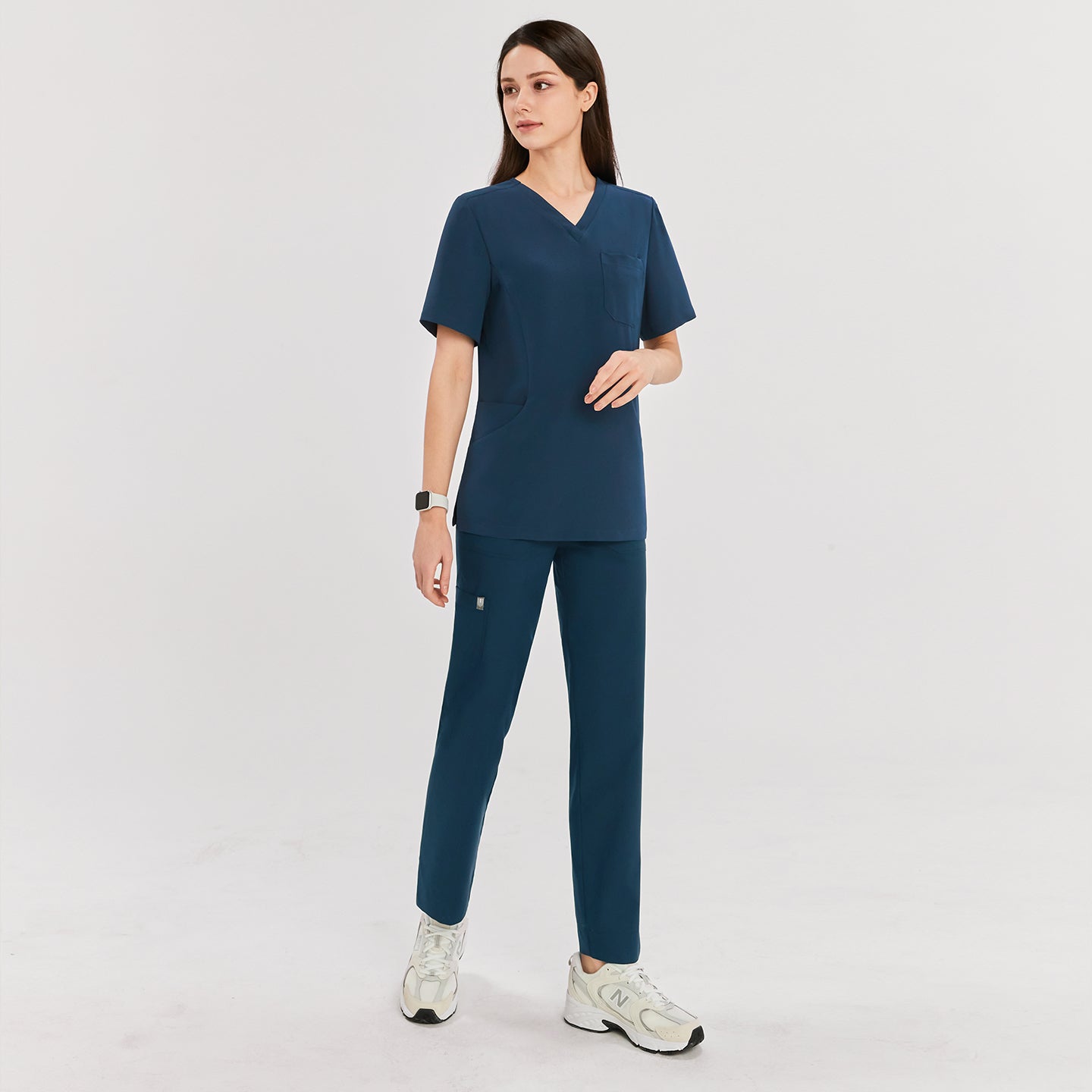 Woman wearing dark blue split hem scrub pants paired with a matching V-neck short sleeve top, showing the full front view,Dark Blue