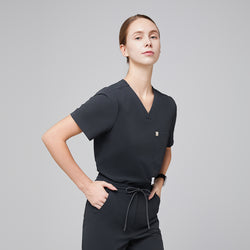 Image of Side view of deep gray V-neck scrub top with short sleeves and a single chest pocket, paired with drawstring scrub pants,Deep Gray