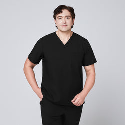 Image of Model wearing an eco black 3-pocket scrub top with a V-neck design, styled with matching scrub pant,Eco Black