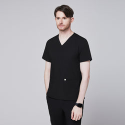 Image of Man in black scrubs with a V-neck and double pockets, looking to the side with a thoughtful expression,Eco Black