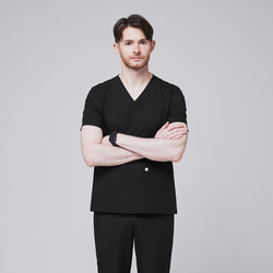 Image of Man wearing black scrubs with a V-neck and double pockets, standing with arms crossed and a confident expression,Eco Black