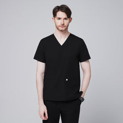 Image of A man wearing an Eco Black Double Pocket Scrub Top with a V-neck and short sleeves,Eco Black