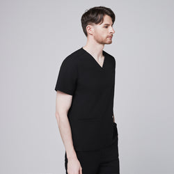 Image of Man in black scrubs with a V-neck and double pockets, looking straight ahead,Eco Black