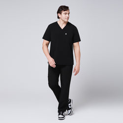 Image of Full-body view of a man wearing a black scrub set with straight-leg pants and a single-pocket V-neck top,Eco Black