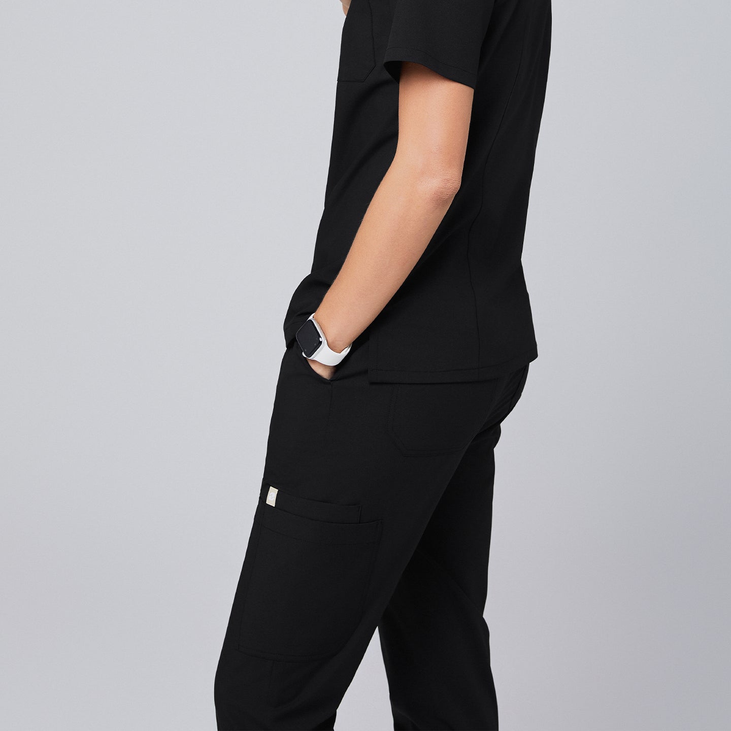 Black jogger scrub pants featuring spacious side pockets and a comfortable, professional design, paired with a matching scrub top,Eco Black