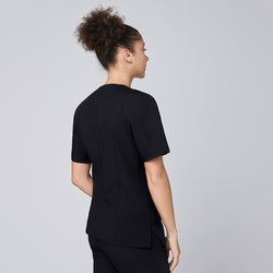 Image of Eco black scrub top with quarter zipper, worn by model with arms relaxed at sides,Eco Black