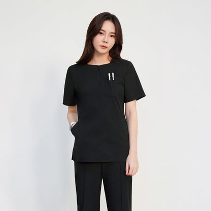 Zenir quarter zipper scrub top on a woman with short sleeves and three pockets,Eco Black