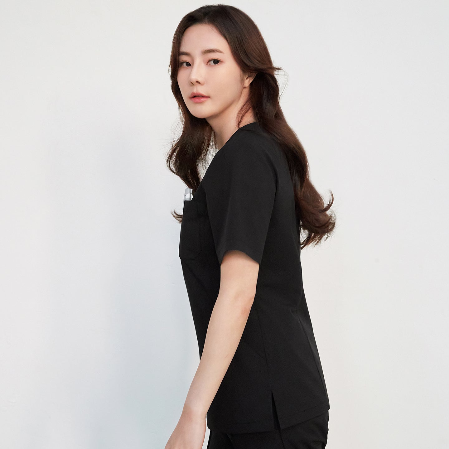 Black Zenir Scrub Top with zipper detail, worn by a woman,Eco Black