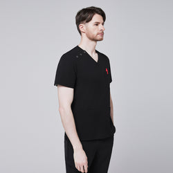 Image of Man wearing Zenir black shoulder button scrub top with side profile, featuring chest and lower pockets and a red pen in the chest pocket,Eco Black