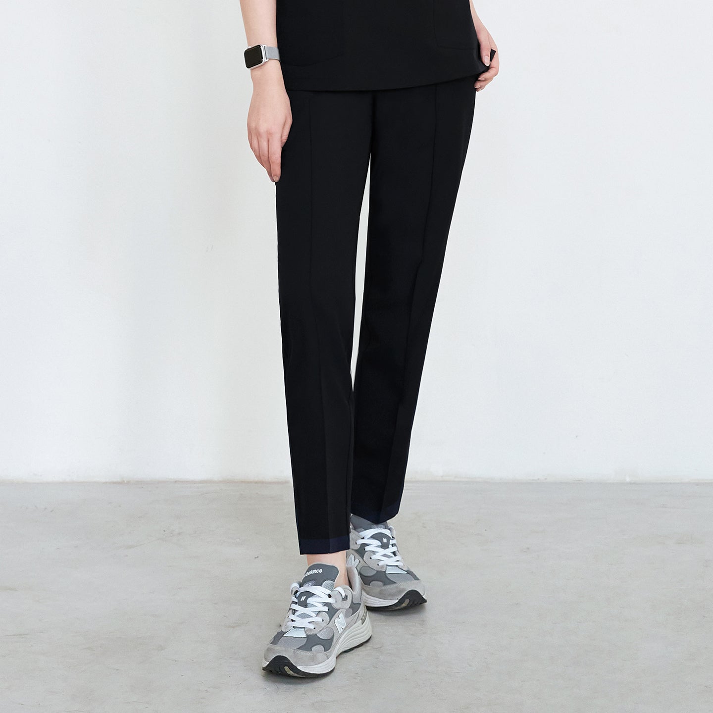 Black scrub pants with straight legs, paired with gray sneakers, shown in a standing position,Eco Black