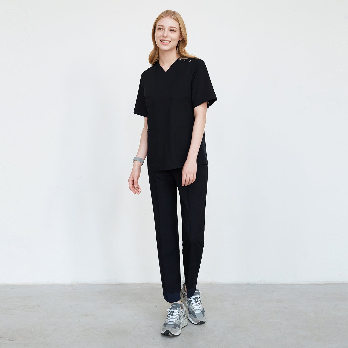 lack scrub set with straight-leg pants, paired with gray sneakers, shown in a walking pose,Eco Black