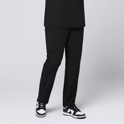 Image of A male model wearing black straight scrub pants with a zipper pocket, paired with black sneakers, standing in a frontal pose,Eco Black