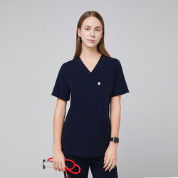 Image of A woman wearing an Eco Navy Single Pocket Scrub Top with short sleeves, holding a red stethoscope,Eco Navy