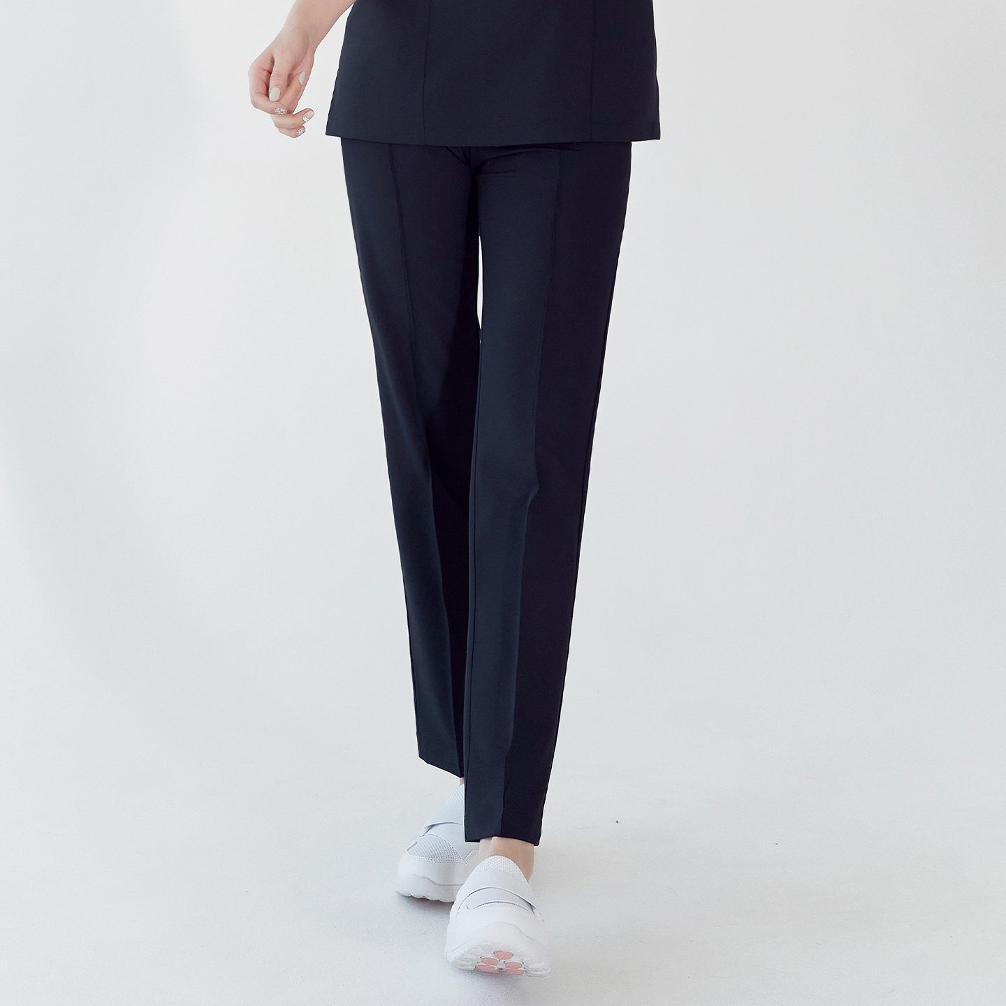 Navy scrub pants with straight legs, paired with white shoes, shown in a walking pose,Eco Navy