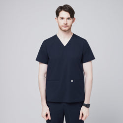 Image of A man wearing an Eco Navy Double Pocket Scrub Top with short sleeves, part of a matching scrub set,Eco Navy