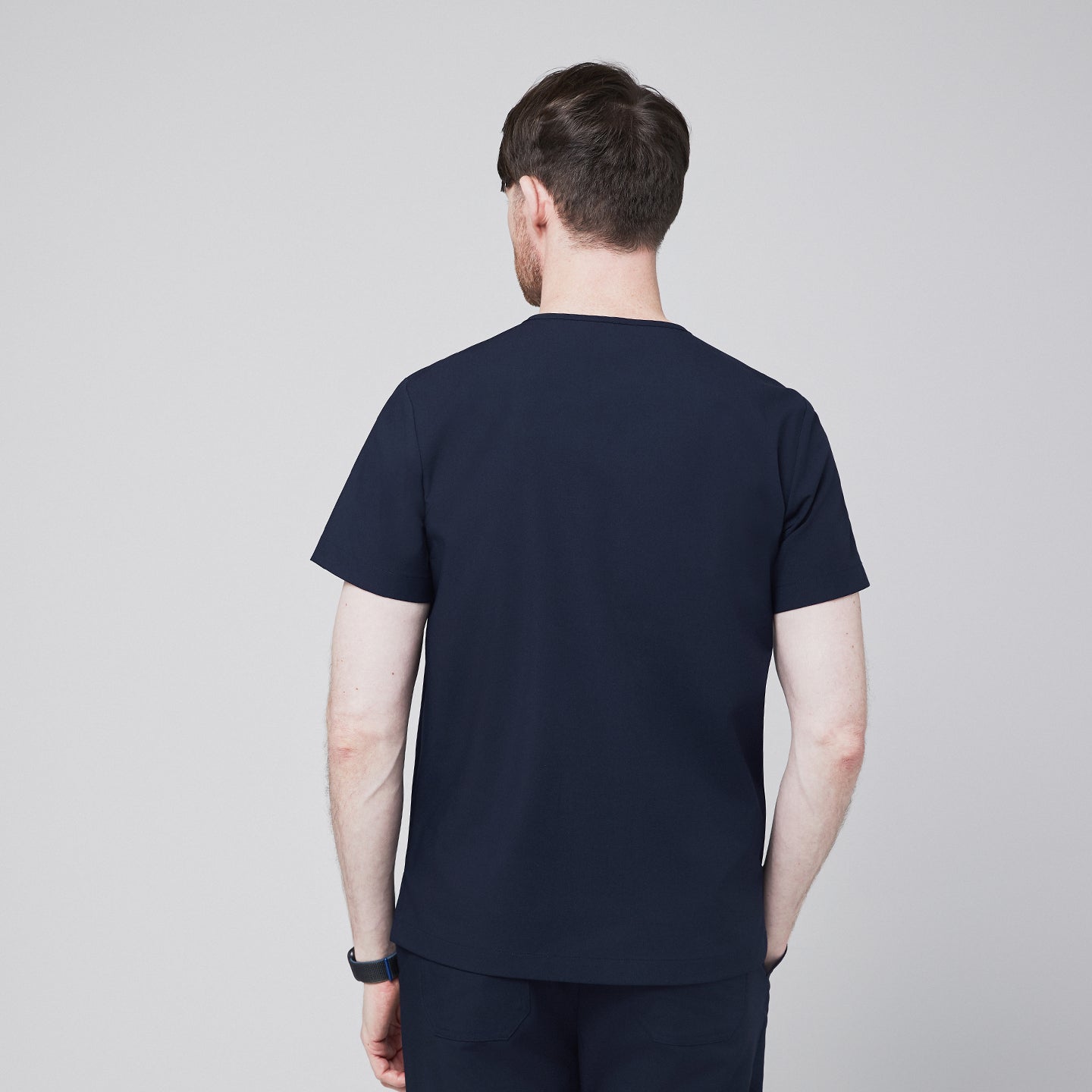 Back view of a men's navy blue scrub top paired with matching navy pants,Eco Navy