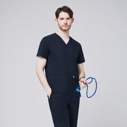 Image of Male model wearing a navy V-neck scrub top with double front pockets, paired with matching scrub pants, holding a blue stethoscope, presenting a professional and modern healthcare uniform style,Eco Navy