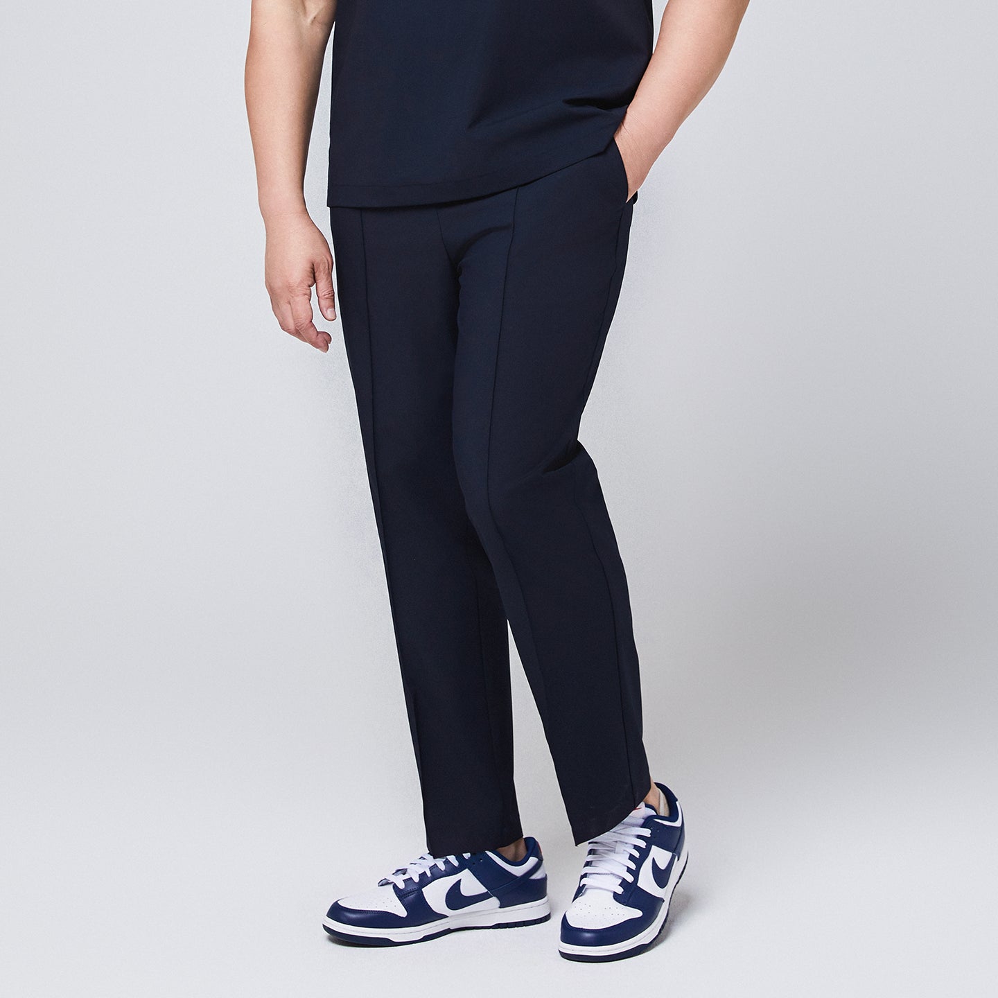 Navy blue M-line banding scrub pants with side pockets, paired with white and blue sneakers,Eco Navy