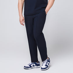 Image of Navy blue M-line banding scrub pants with side pockets, paired with white and blue sneakers,Eco Navy