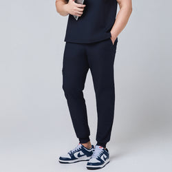 Image of Side view of navy jogger scrub pants featuring a zipper pocket and elastic cuffs,Eco Navy