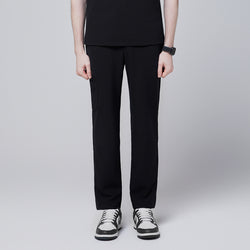 Image of Male model standing upright, wearing jet black relaxed-fit scrub pants with side pocket detailing, demonstrating a professional and sleek appearance,Jet Black