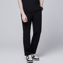 Image of Male model wearing jet black relaxed-fit scrub pants with side pocket detailing, standing with one hand in pocket, showcasing a casual and polished look,Jet Black